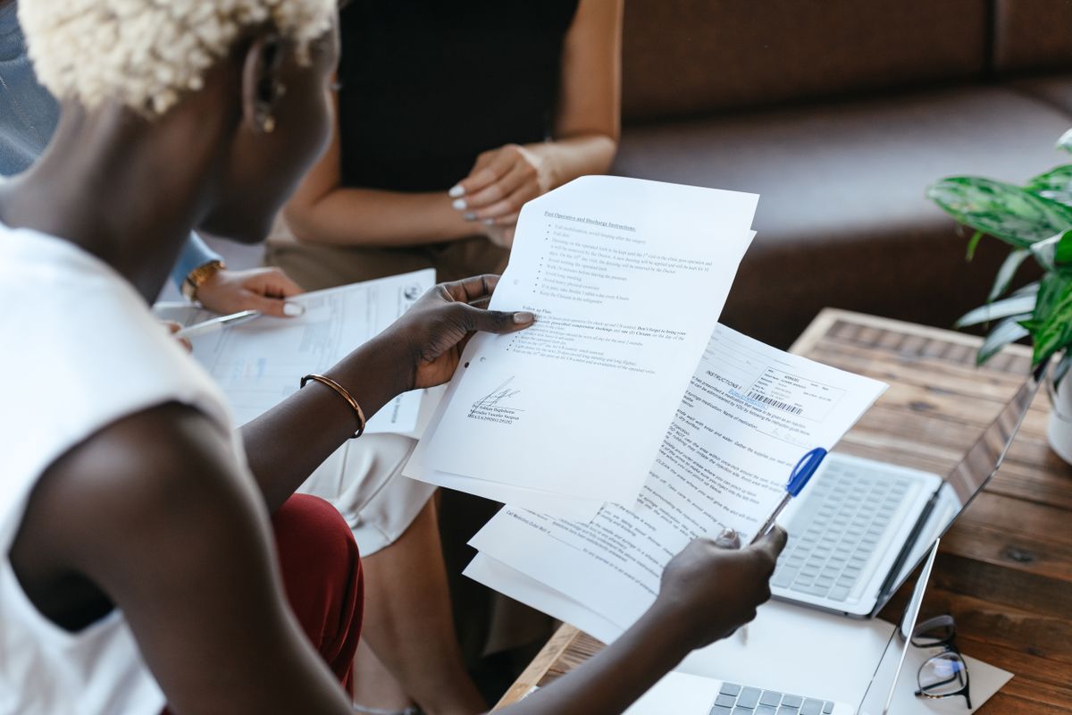 Two professionals comparing documents in an office