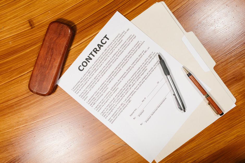 Two business professionals reviewing a contract document